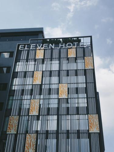 a building with a sign on the side of it at Eleven Hotel Bangkok Sukhumvit 11 in Bangkok