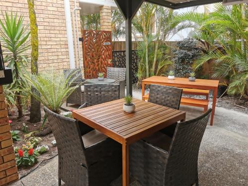 a wooden table and chairs on a patio at Limassol Motel in Gold Coast