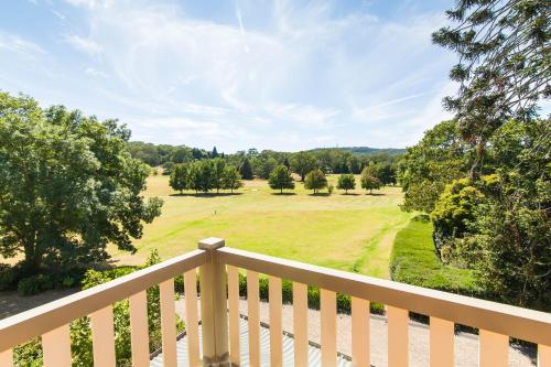 a view from the deck of a home with a field at Peppers Craigieburn Resort in Bowral
