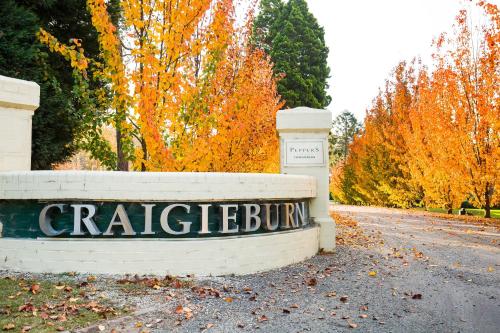a sign for a car dealership in front of trees at Peppers Craigieburn Resort in Bowral
