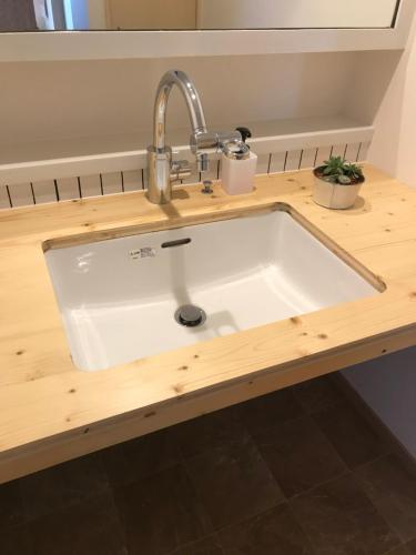 a kitchen sink with a faucet on a counter at Sapporo Guest House 庵 Anne in Sapporo