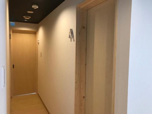 a hallway with an a sign on the wall at Sapporo Guest House 庵 Anne in Sapporo