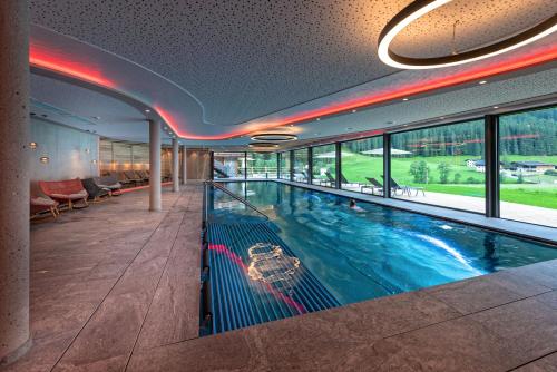 a large indoor swimming pool in a building at Alpinhotel Berghaus spa in Tux