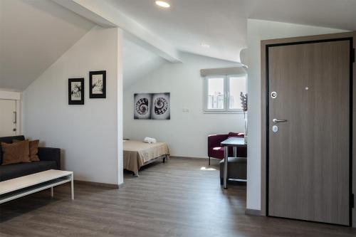 a room with a door leading to a bedroom at Silver Apartment - Loft in Limassol