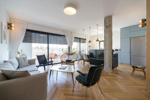 a living room with a couch and a table at Beach Apartments TLV - Exclusive in Tel Aviv