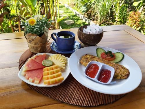 a tray with two plates of food on a table at Ayuna Family Ubud in Ubud