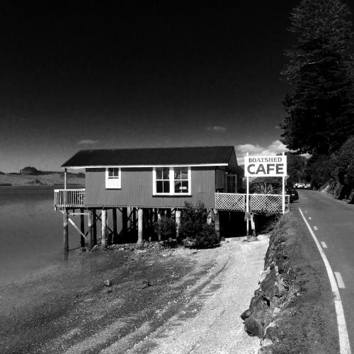 a house on the side of a road with a sign at Marriners Luxury Guesthouse in Rawene