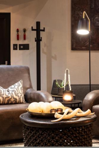 a living room with a couch and a table with a cross at 57 Waterberg in Welgevonden Game Reserve