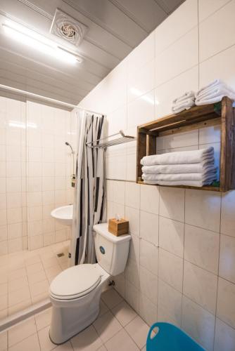 a white bathroom with a toilet and a sink at 安平寵物島 民宿 in Tainan