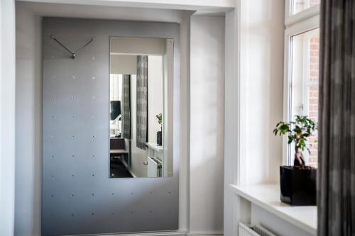 a mirror on a wall in a room at Hotel Koldingfjord in Kolding