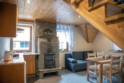 a living room with a stone fireplace in a house at Apartament An-Mi in Zakopane