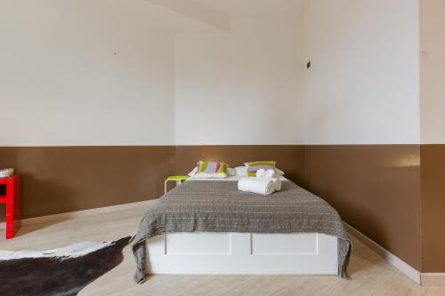 a bedroom with a bed with two pillows at Domus Athesis al Teatro Romano in Verona