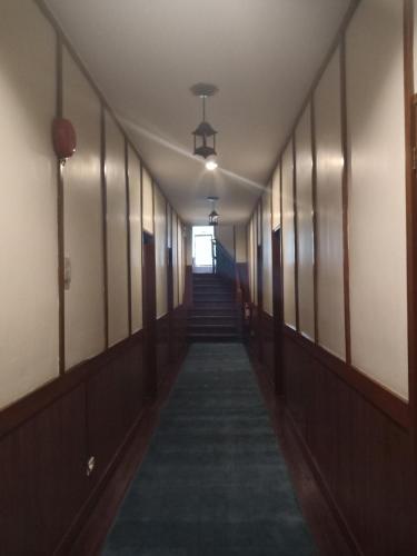 a hallway in an office building with stairs and lights at Casa Vallejo Hotel Baguio in Baguio