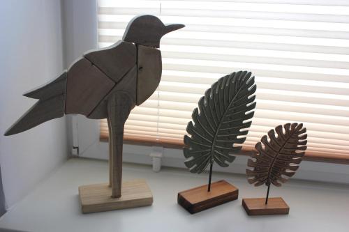 a statue of a bird sitting on three wooden stands at Das BilderbuchCafe - Ferien - Apartment NO 3 - Markt 7 in Havelberg