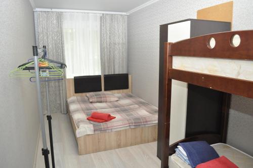 a small bedroom with a bunk bed with a mirror at Apartments in the heart of Kursk on Radischeva street in Kursk