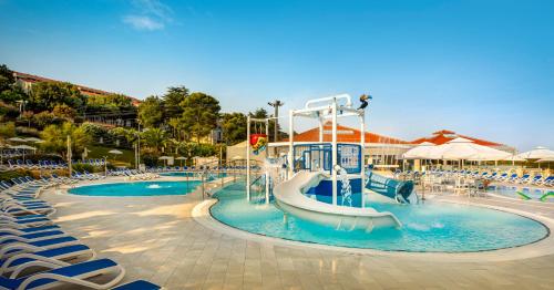 a pool with a water slide in a resort at Maistra Select Belvedere Resort in Vrsar