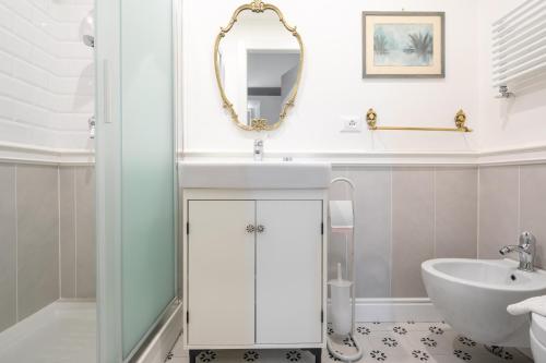 a bathroom with a sink and a mirror at Santa Maria Novella 4 bedrooms in Florence