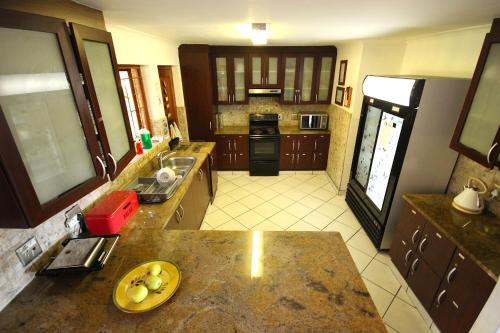 a kitchen with a counter with a plate on it at Saltycrax Backpackers and Surf Hostel in Bloubergstrand