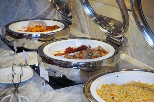 three plates of different types of food on a table at Eleven Hotel Bangkok Sukhumvit 11 in Bangkok