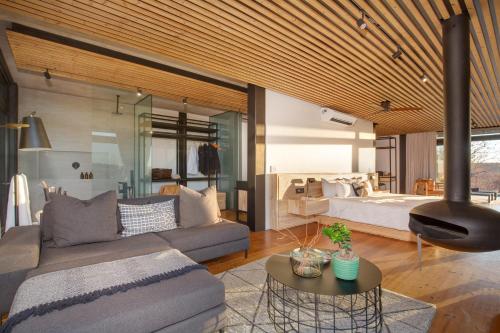 a living room with a couch and a bed at 57 Waterberg in Welgevonden Game Reserve