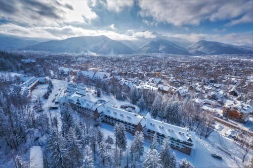 an aerial view of a city covered in snow at Kompleks Antałówka Termy & Med in Zakopane