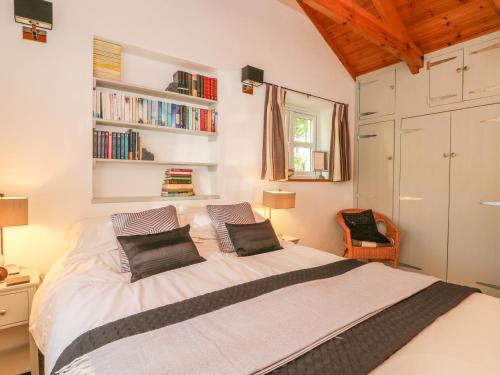 a bedroom with a large white bed with two pillows at Pond Cottage in Truro