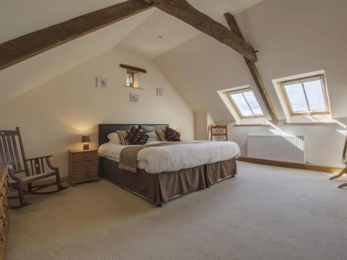 a bedroom with a large bed in a attic at Butterdon Barn in Moretonhampstead