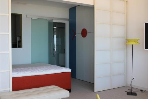 a bedroom with a bed and a sliding glass door at Residence Paris Seaview Zeezicht Vue Mer in Ostend