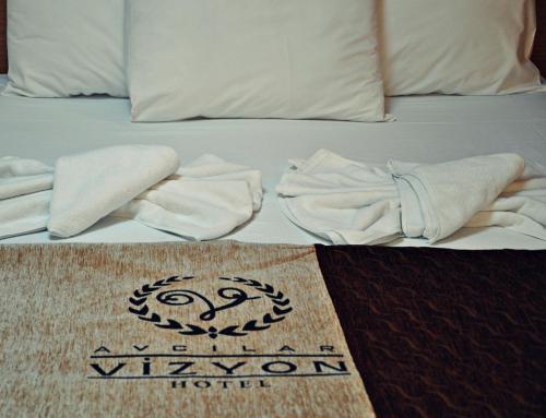 a bed that has some pillows on it at Avcilar Vizyon Hotel in Istanbul