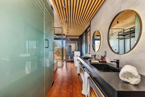 a bathroom with a sink and a mirror at 57 Waterberg in Welgevonden Game Reserve