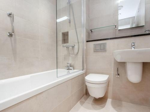 a bathroom with a toilet and a sink and a shower at 2 Burgh Island Causeway in Bigbury on Sea