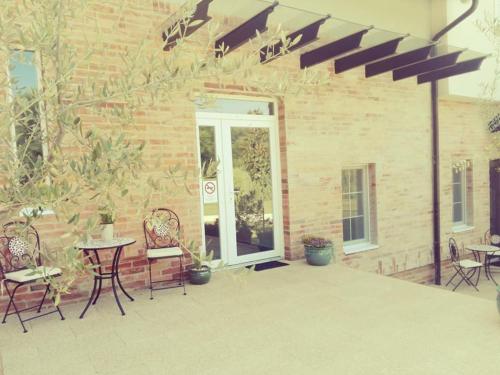 a patio with chairs and a table and a table and chairs at Varga Villa in Orfű