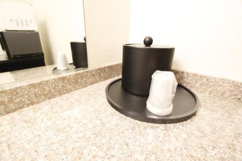 a towel sitting on a counter in a bathroom at Welcome Inn Corona in Corona