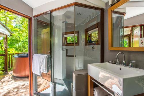 a bathroom with a shower and a sink at Geejam in Port Antonio