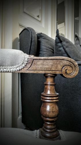 a wooden stand in front of a couch at Bohemian Suites Athens in Athens