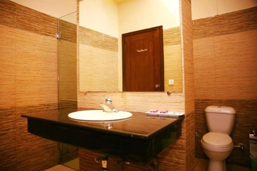 a bathroom with a sink and a toilet at Magnolia Boutique House in Islamabad