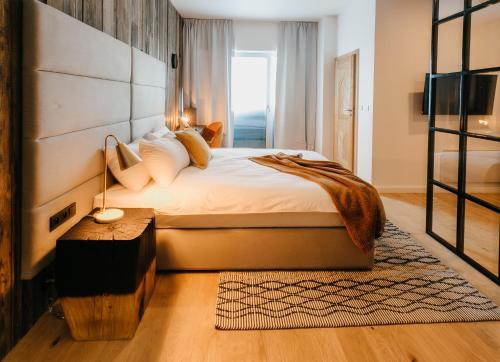 a bedroom with a large bed and a window at Ski&Sun Apartamenty in Świeradów-Zdrój
