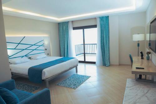 a hotel room with a bed and a balcony at Gravity Hotel & Aqua Park Hurghada Families and Couples Only in Hurghada