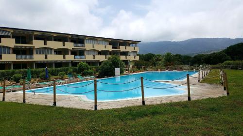 a large swimming pool in front of a hotel at residenza " Verde Blu " in Capoliveri