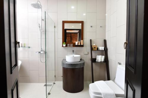 a bathroom with a sink and a glass shower at El Barrio Lanna in Chiang Mai