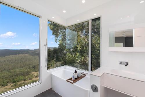 a bathroom with a tub and a large window at 629 Balmoral Ridge in Balmoral Ridge
