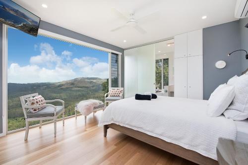 a bedroom with a bed and a large window at 629 Balmoral Ridge in Balmoral Ridge