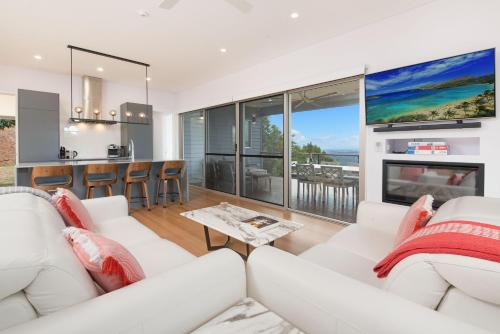 a living room with a white couch and a fireplace at 629 Balmoral Ridge in Balmoral Ridge