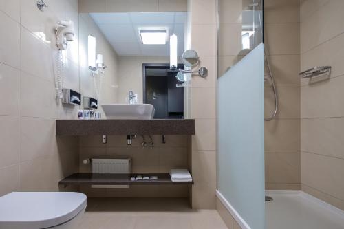 a bathroom with a toilet and a sink at Mercure Wrocław Centrum in Wrocław