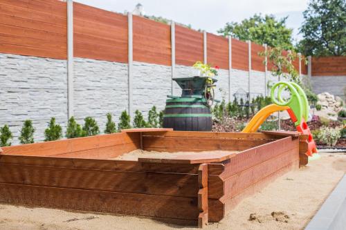 a wooden planter in a sandbox in a garden at Penzion Čáp in Mikulov