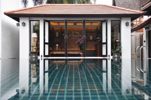 a villa with a swimming pool in a house at El Barrio Lanna in Chiang Mai