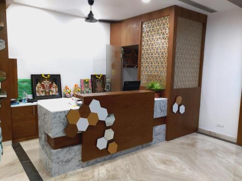 a room with a reception desk with a table in it at Hotel Sri Ram Grand in Vijayawāda