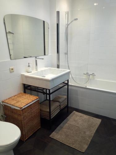 a bathroom with a sink and a shower and a toilet at Holiday Home Jules in Antwerp