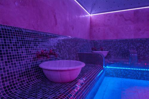 a pink bathroom with a tub and pink lights at Katalina SPA Resort in Tsigov Chark