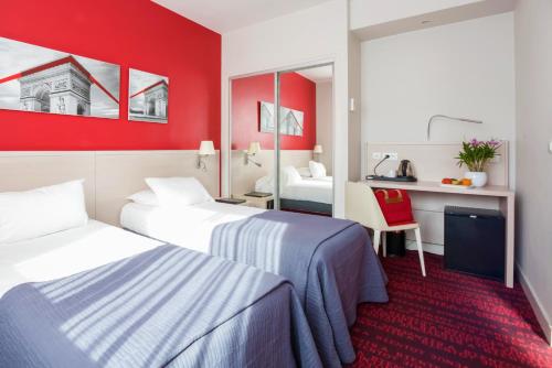 a hotel room with two beds and a red wall at Hotel Le Richemont in Paris